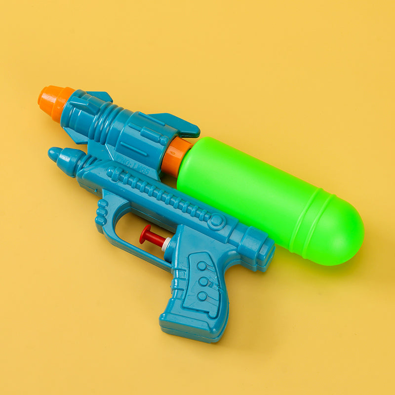 Toy water gun with blue body and green barrel on a yellow background