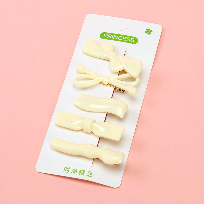 Set of cream-colored hair clips on a white card with 'PRINCESS' branding on a pink background