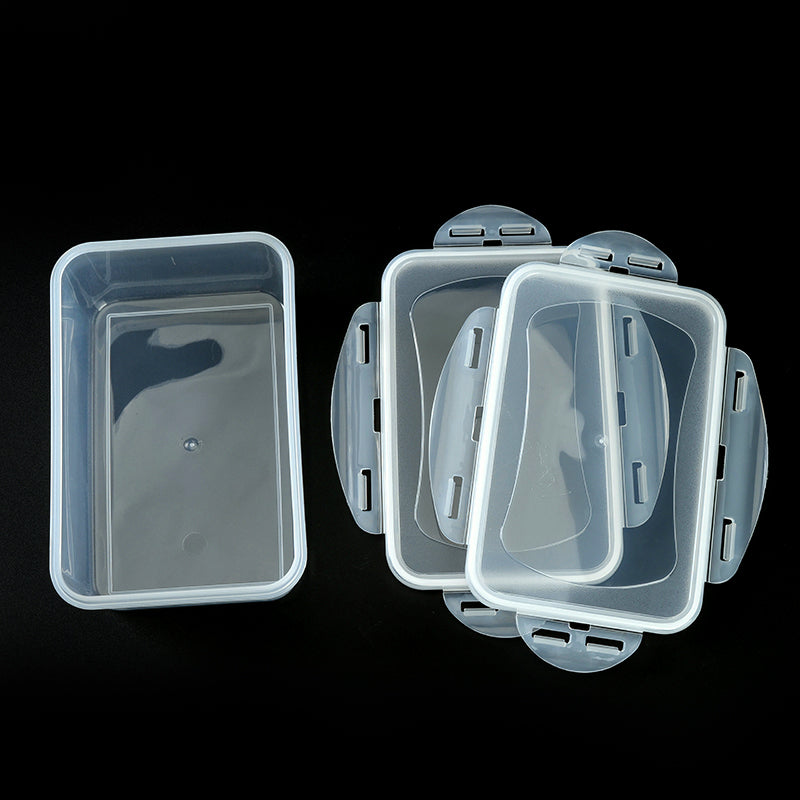 Set of clear plastic containers with lids on a black background