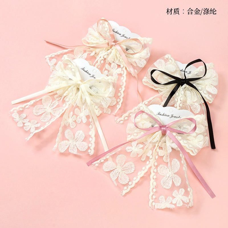 Two decorative items with lace and ribbons on a pink background