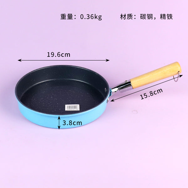 Small frying pan with measurements on a pink background