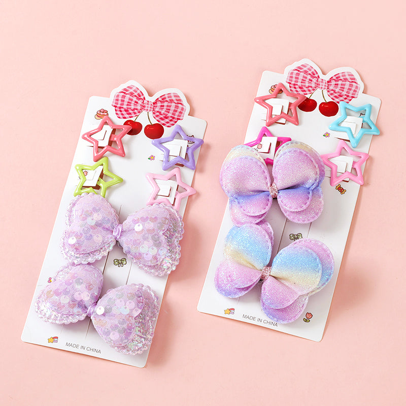 Two packages of colorful hair bows on a pink background