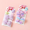 Two packages of colorful hair bows on a pink background