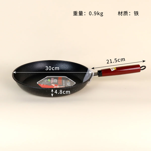 Black frying pan with measurements on a beige background