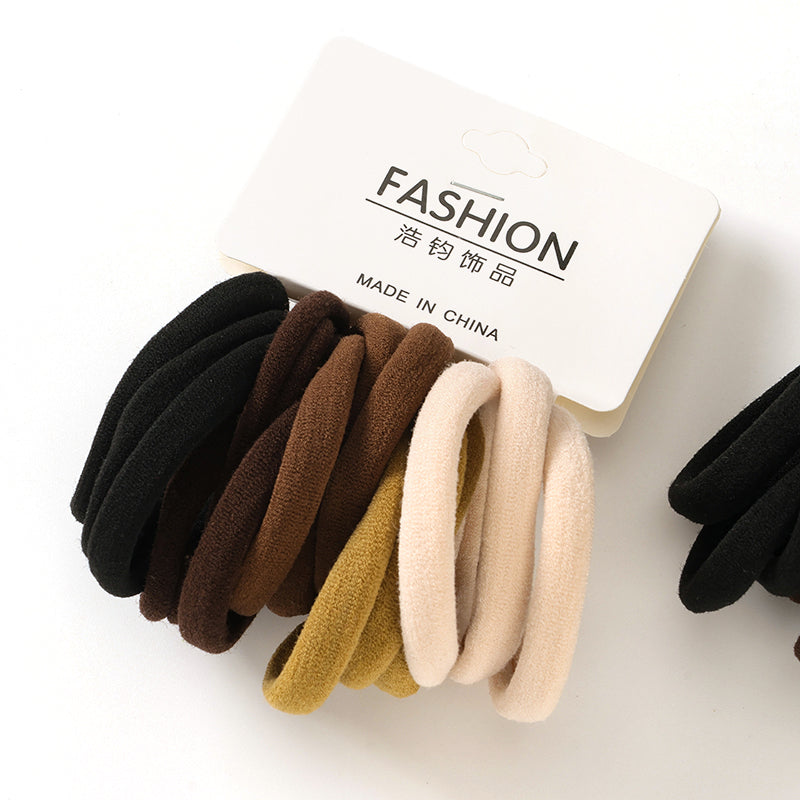 Set of hair ties in black, brown, beige, and yellow on a white background with 'FASHION' label.