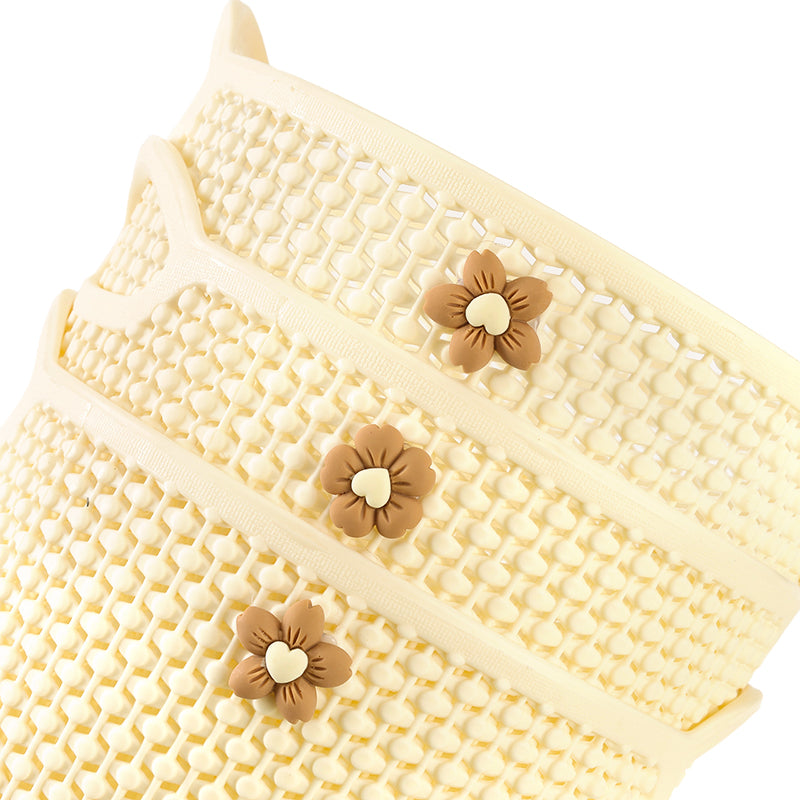 Woven basket with decorative flowers on a white background