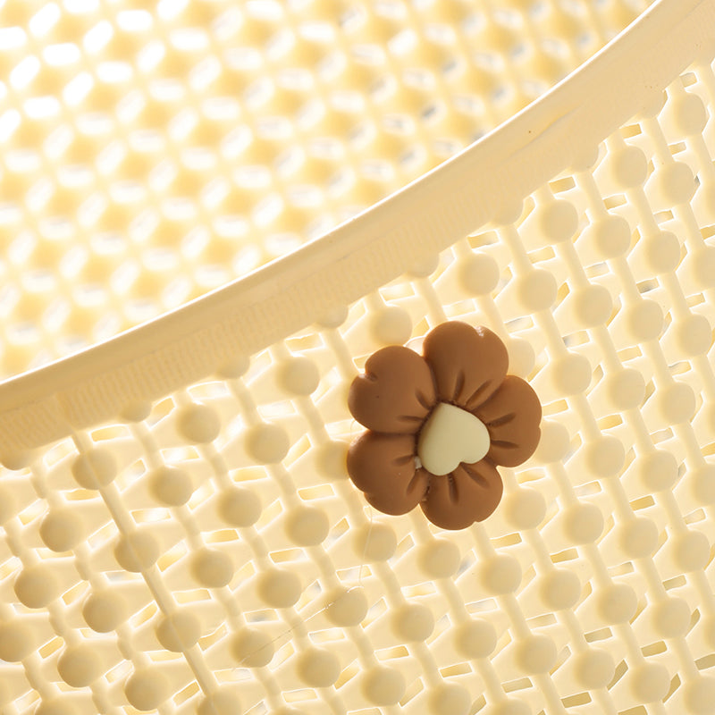 Close-up of a brown flower-shaped object on a textured beige surface