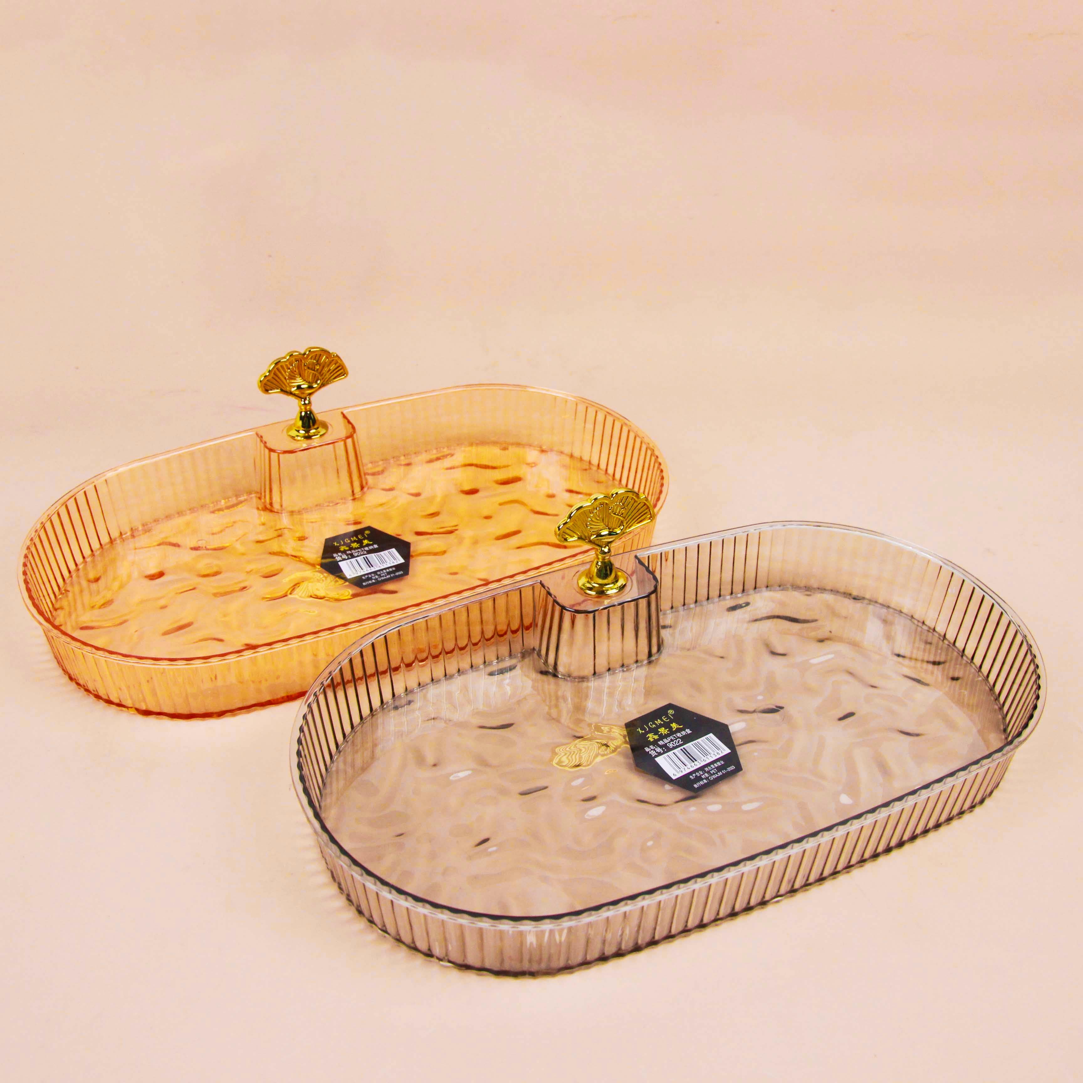 Two decorative trays with gold accents on a beige background