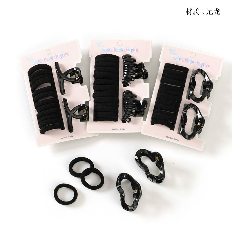 Set of black hair ties and clips on white background