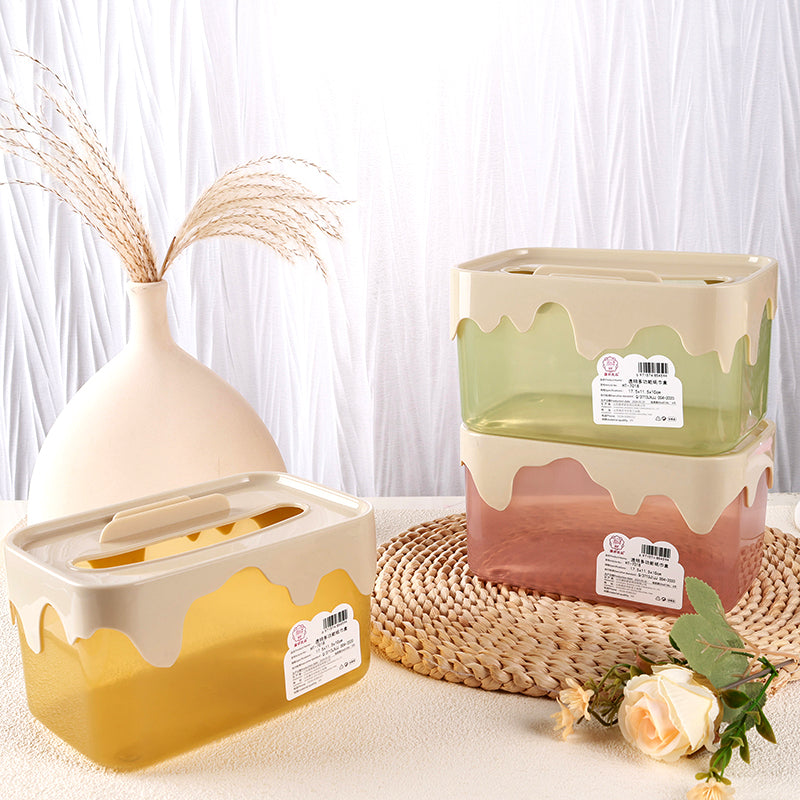 Two decorative storage boxes with a vase and flowers on a textured surface.