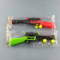 Two toy guns, one red and black, one green and black, with yellow balls on a gray background.