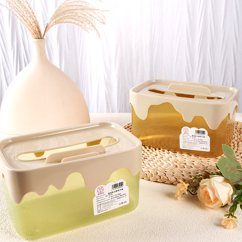 Two beige and green containers with lids on a light surface with decorative elements.